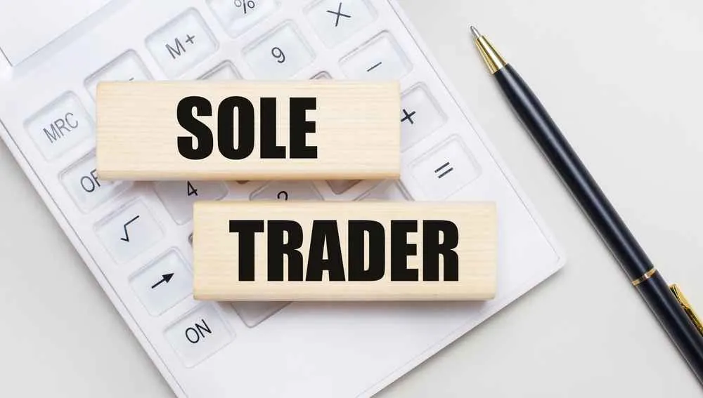 A businessman pointing at self assessment tax return button representing HMRC filing process for sole traders in the UK
